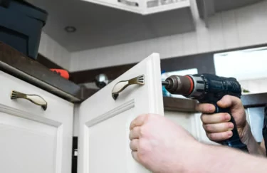 Example photo of a kitchen cupboard door being refitted