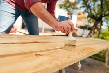 Handyman varnishing a wooden worktop